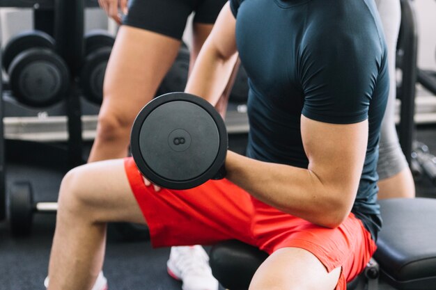 Muscular man holding dumbbell