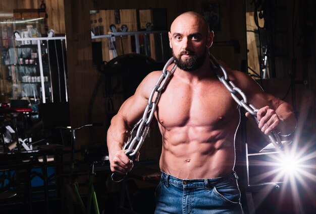 Muscular man posing with chain