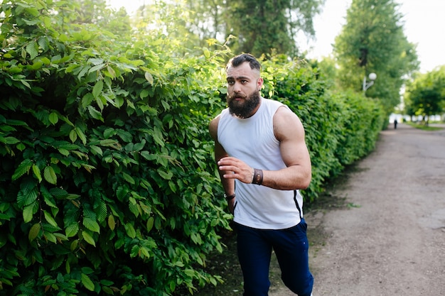 Muscular man running outdoors