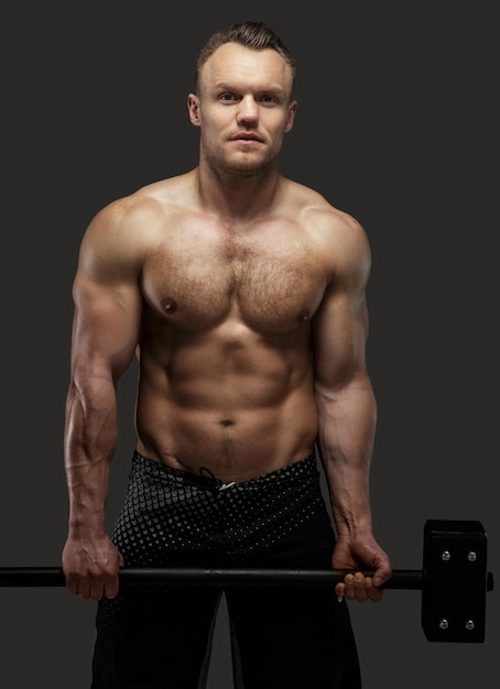 Free photo muscular shirtless guy holding big hummer. isolated on grey background