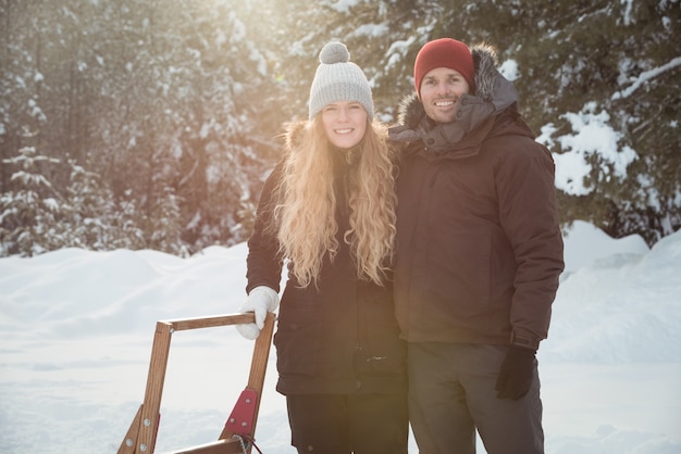 Mushers standing beside sleigh