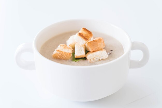 mushroom soup and bread in white ceramic cup