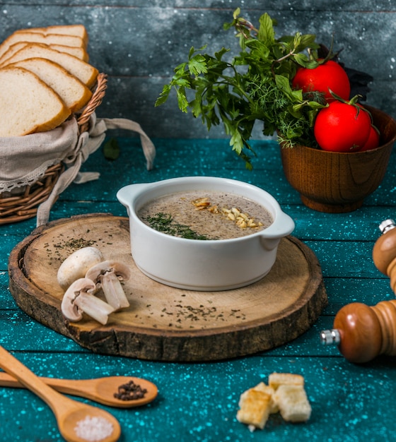 Mushroom soup with walnuts on wooden board