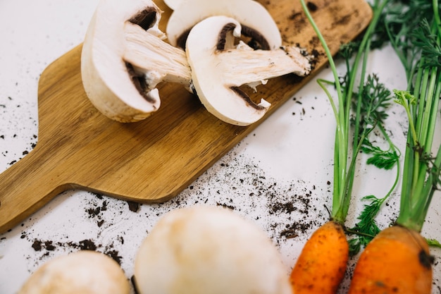 Mushrooms and carrots with soil