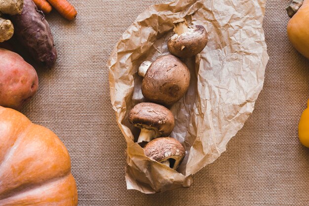 Mushrooms lying near vegetables