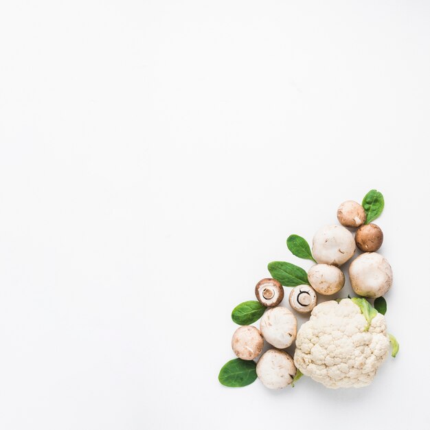 Mushrooms and spinach near cauliflower