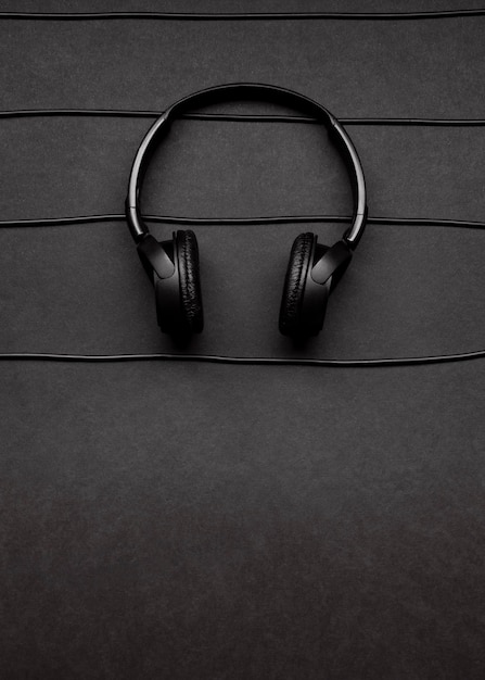Music arrangement with black headphones and cables with copy space