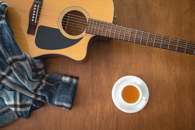 Music background with acoustic guitar top view