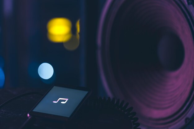 Music background with phone and with music icon and column, modern technology concept, listening to music.