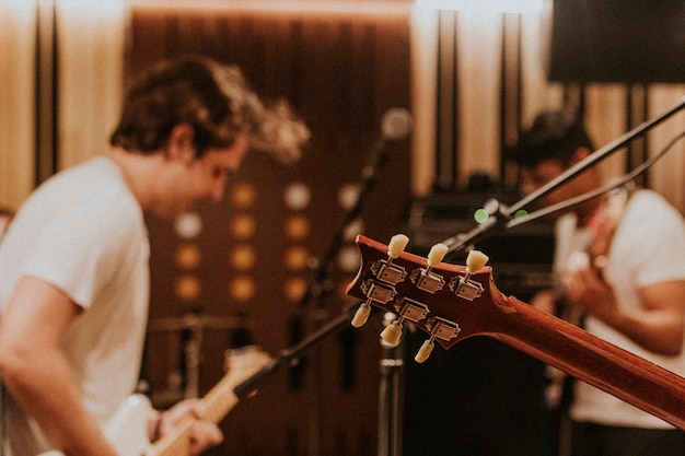 Music band guitarist performing repetition in recording studio