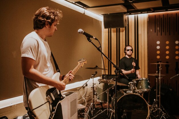 Music band guitarist performing repetition in recording studio