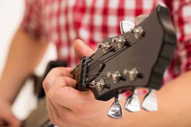 Music, close-up. Musician holding a wooden guitar