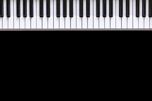 Musical background with musical keys on black, flat lay, copy space.