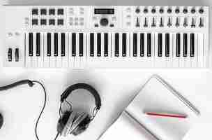 Free photo musical flat lay background with headphones musical keys