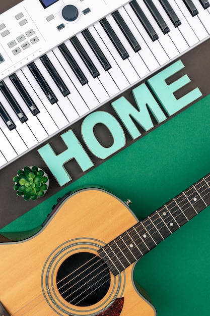 Musical keys guitar and decorative word home on a colored background