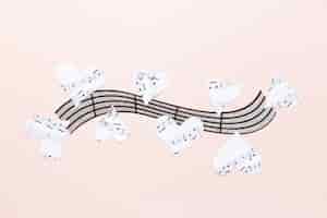 Free photo musical stave with hearts on plain background