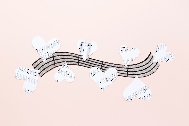 Free Photo musical stave with hearts on plain background