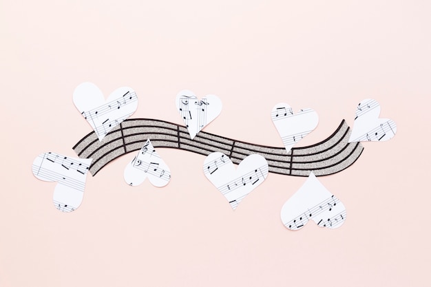 Musical stave with hearts on plain background