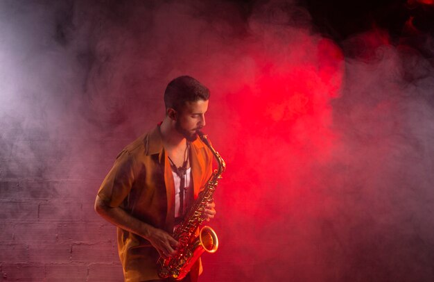 Musician in fog playing the saxophone