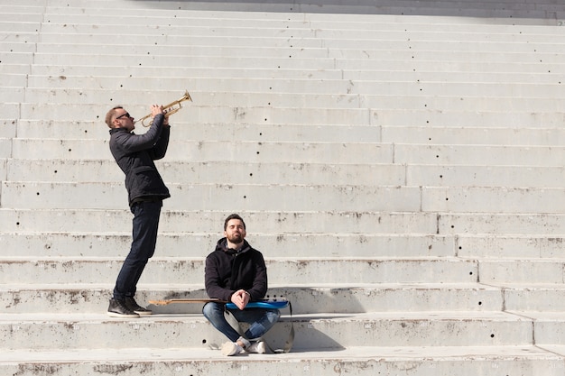 Free photo musician friends in a stadium