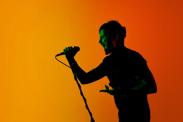 Musician isolated on dark studio in neon light