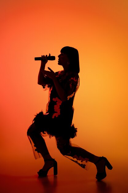 Musician isolated on dark studio in neon light