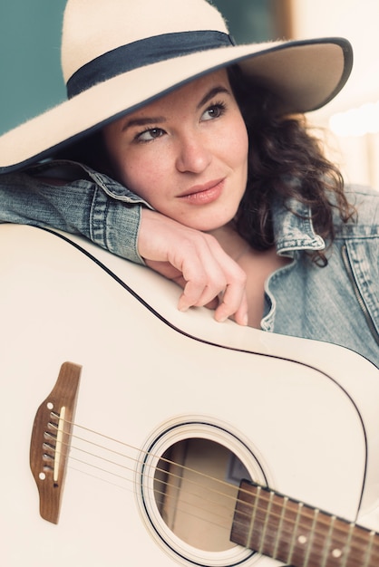 Free photo musician leaning on guitar