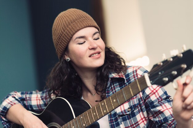 Musician playing on her guitar