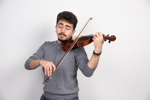 Musician plays a romantic classic piece at his violin.
