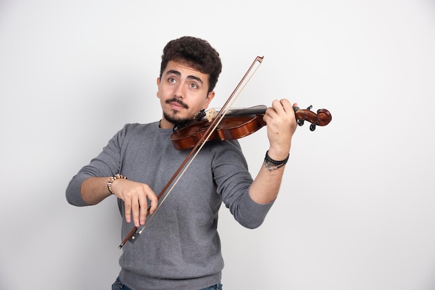 Musician plays a romantic classic piece at his violin.