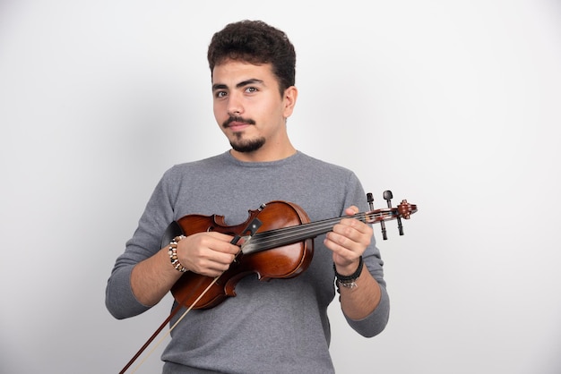 Musician plays a romantic classic piece at his violin.