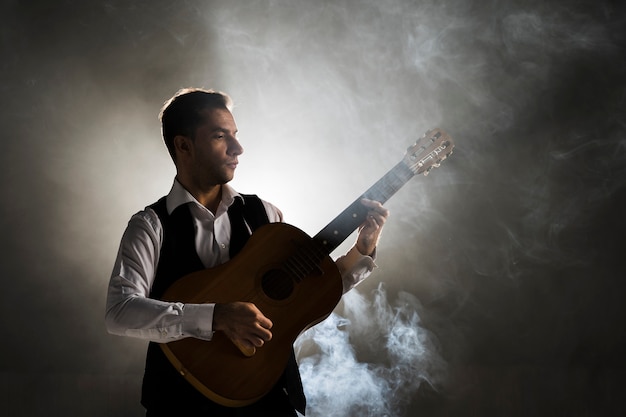 musician on stage playing the guitar
