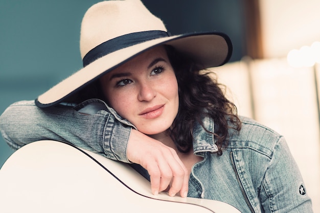 Musician with cowboy hat and guitar