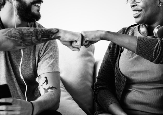 Musicians fist bumping on a couch