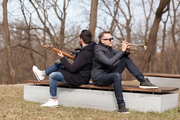 Musicians leaning against each other