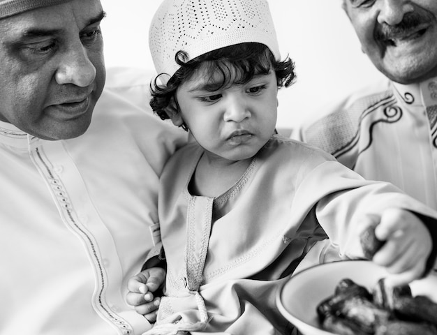 Muslim boy eating dried dates