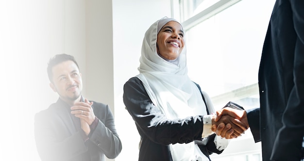 Muslim businesswoman shaking hands for a business agreement