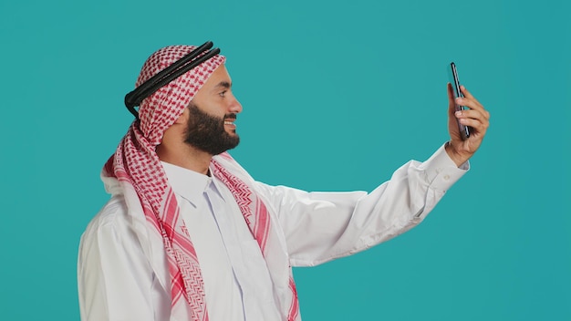 Free photo muslim guy takes pictures with phone