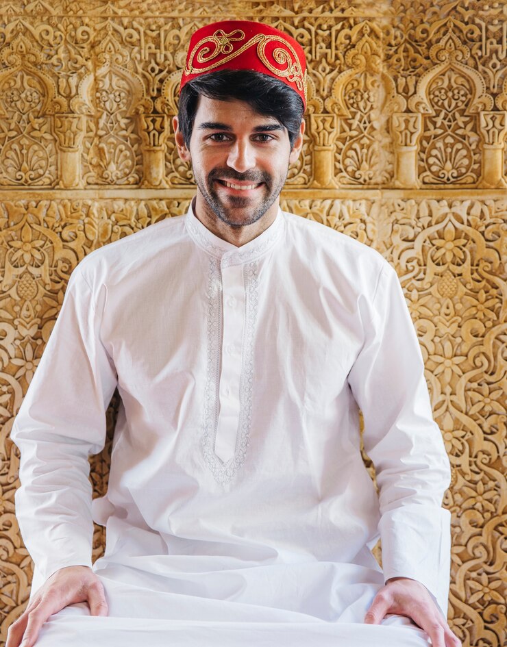 Muslim man in front of golden wall