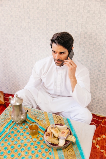 Muslim man making phone call