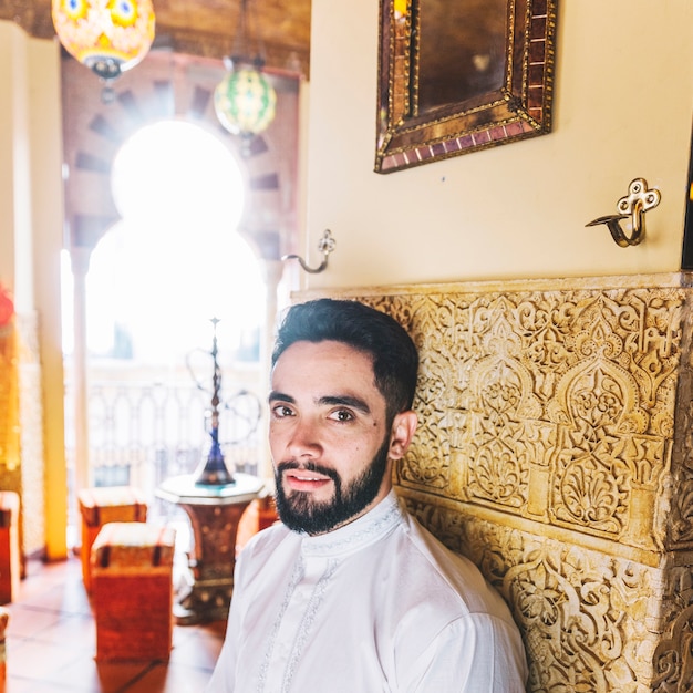 Muslim man sitting in restaurant