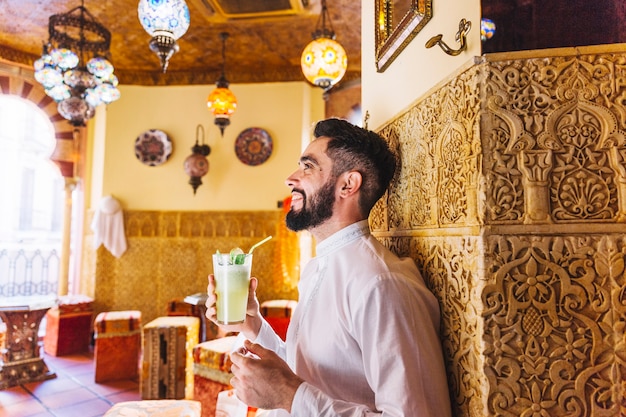 Free photo muslim man sitting in restaurant