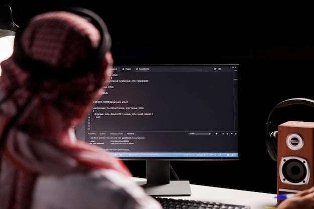 Free photo muslim man using a desktop computer