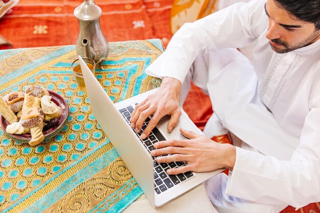 Muslim man using laptop