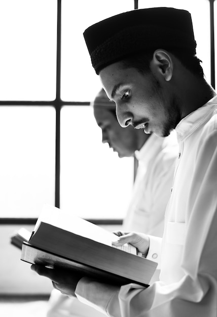 Muslim men reading Quran during Ramadan