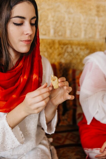 Muslim woman holding glass of tea