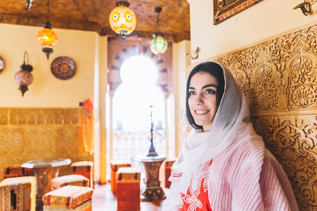 Muslim woman leaning against wall