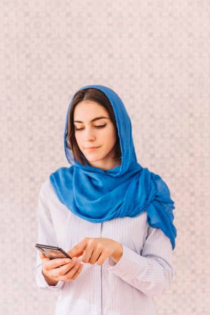 Muslim woman with smartphone