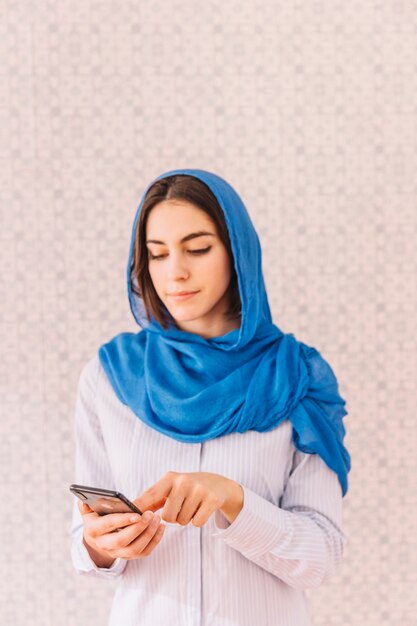 Muslim woman with smartphone