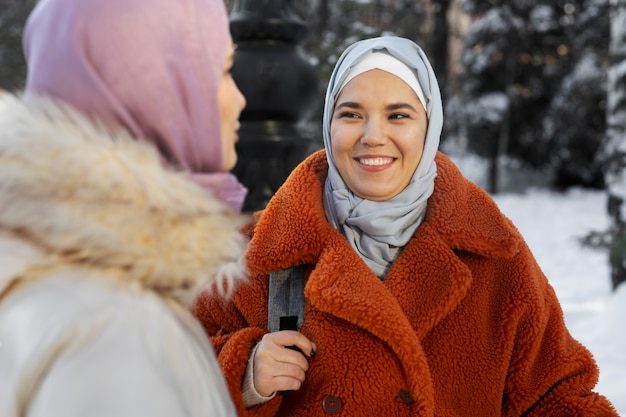 Бесплатное фото Мусульманки улыбаются и исследуют город во время отпуска